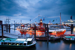 Illuminated fireboat in harbor at night, Hamburg, Germany