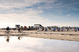 Cyclists and beach chairs on the beach, St. Peter Ording, Eiderstedt peninsula, Schleswig Holstein, Germany, Europe