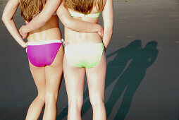 girl 13, girl 18 yrs standing together on beach