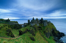 The ruins of Dunluce Castle on shore, County Antrim, Ireland, Europe