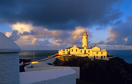 Lighthouse on the rocky coastline in the evening light, Fanad Head, County Donegal, Ireland, Europe