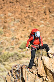 A woman climbing on a ridge, Teide National Park, Tenerife, Canary Islands