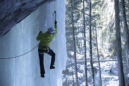 Ice climber on frozen waterfall, Immenstadt, Bavaria, Germany