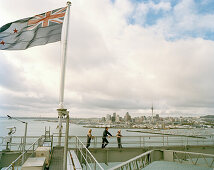 People on the steel arches of Harbour Bridge under clouded sky, Waitemata Harbour, Auckland, North Island, New Zealand