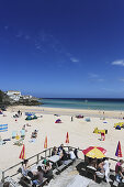 People sunbathing at Porthminster Beach, St. Ives, Cornwall, England, United Kingdom