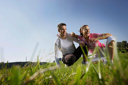 Couple crouching on grass