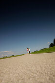 Couple standing on road, Munsing, Bavaria, Germany
