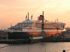 Cruise ship Queen Mary 2 at the shipyard in the evening, Hanseatic City of Hamburg, Germany