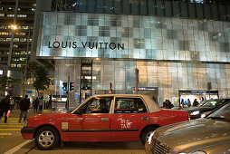 Taxi in front of Louis Vuitton shop in Canton Road at night, Kowloon, Hong Kong, China, Asia