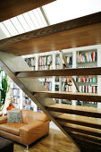 Livingroom furnitures with sofa, stairs and bookshelves in loftstyle