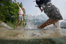 Young couple in lake Eibsee, Werdenfelser Land, Bavaria, Germany