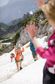 Young people snowball fighting, Werdenfelser Land, Bavaria, Germany