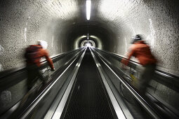 Mountain biker riding down an escalator, Ischgl, Tyrol, Austria