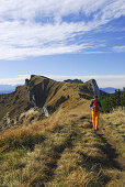 Woman hiking to Brauneck, Bavarian foothills, Bavaria, Germany