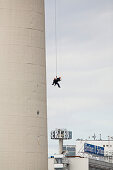 Two industrial climbers abseiling on the tower of Berlin's Television Tower, Alex, Berlin, Germany