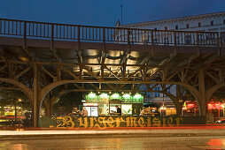 Illuminated snack under the subway station in the evening, Schlesisches Tor, Berlin, Germany, Europe