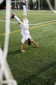 ians, Child, Children, Color, Colour, Contemporary, Daytime, Equilibrium, Expressive, Expressiveness, Exterior, Fair-haired, Football, Football ground, Full-body, Full-length, Fun, Goal, Goalie, Goali