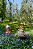 Two girls on a flower meadow, South Tyrol, Italy, Europe