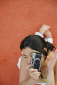 Latino Woman holding a camera.