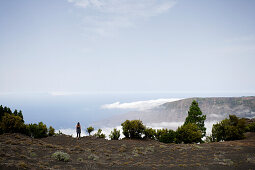 Hiker, a woman, admiring the view over El Golfo, clouds, Camino de la Virgin, Malpaso, El Hierro, Canary Islands, Spain