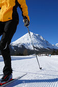Woman cross-country skiing, Hohe Munde in background, Leutasch, Tyrol, Austria