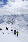 Group of backcountry skiers ascending and descending summit of Lamsenspitze, Sellrain, Stubai range, Tyrol, Austria