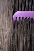 Adult, Adults, Brunette, Brunettes, Close up, Close-up, Closeup, Color, Colour, Comb, Combing, Combs, Contemporary, Dark-haired, detail, details, Female, Girl, Girls, Hair, Hair care, Haircare, human, indoor, indoors, interior, Lilac, Long hair, Long hair