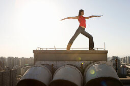 Woman doing yoga on roof