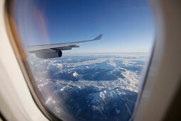 View through airplane window over Rocky Mountains, Oregon, USA