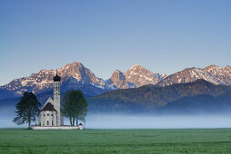 St. Coloman church in morning mist, near Schwangau, Allgaeu, Bavaria, Germany