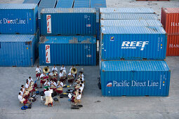 Tongan Brass Band playing amidst containers at harbour, Nuku'alofa, Tongatapu, Tonga, South Pacific, Oceania