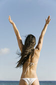 Woman stretching by the sea