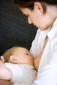 Woman breastfeeding baby girl (8 month), Vienna, Austria