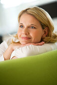 Woman lying happily on couch