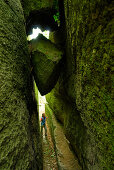 Woman standing in cleft, Castle Falkenstein, Bavarian Forest, Upper Palatinate, Bavaria, Germany