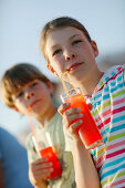 Girl and boy with fruit Juice, Formentera, Balearic Islands, Spain