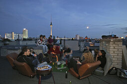 Young people having a roof party, Prenzlauer Berg, Berlin, Germany