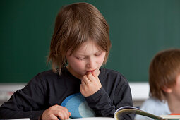 Schoolboy reading a book, Hamburg, Germany