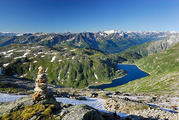 Cairn above reservoir Lago della Sella, Gotthard range, Canton of Ticino, Switzerland