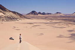 Tourist on 50-Meter Dune in Black Desert, Egypt, Libyan Desert