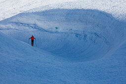 Back-country skier in front of snowdrift, Canton of Ticino, Switzerland