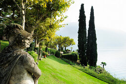 Skulpturen und Zypressen im Park der Villa del Balbianello, Lenno, Comer See, Lombardei, Italien