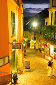 Illuminated alley with restaurants, Bellagio, Lake Como, Lombardy, Italy