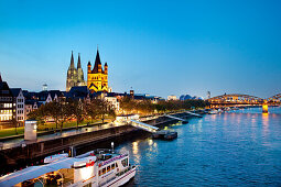 View over river Rhine to old town with cathedral and Great St. Martin church, Cologne, North Rhine-Westphalia, Germany