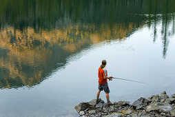 Fisherman trying his luck at Copper Glance Lake,  Okanogan National Forest Wasington USA