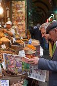 Turkish men with newspaper in Egyptian Bazaar, Istanbul, Turkey