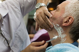 tourist at traditional barber, with shaving razor, Istanbul, Turkey