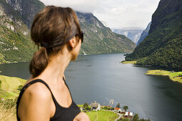 Young woman looking at the Naerofjord, Sogn og Fjordane, Norway, Scandinavia, Europe