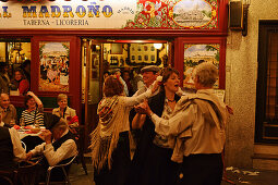 Couples dancing in front of Madrono restaurant, Fiestas de San Isidro Labrador, Madrid, Spain