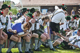 Young people wearing traditional costumes, May Running, Antdorf, Upper Bavaria, Germany